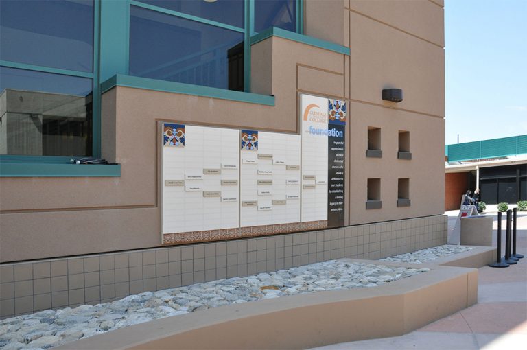 Legacy society donor recognition display featuring a grid of donor nameplates, tile-inspired accents, and Glendale College Foundation branding in an outdoor courtyard.