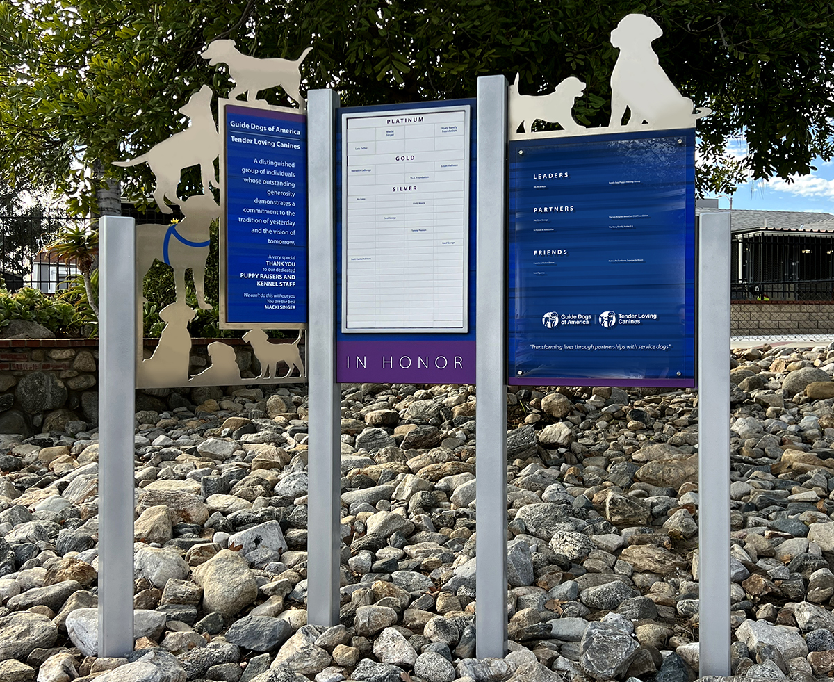 Outdoor, freestanding donor recognition wall utilizing magtech and cleat change systems for Guide Dogs of America.