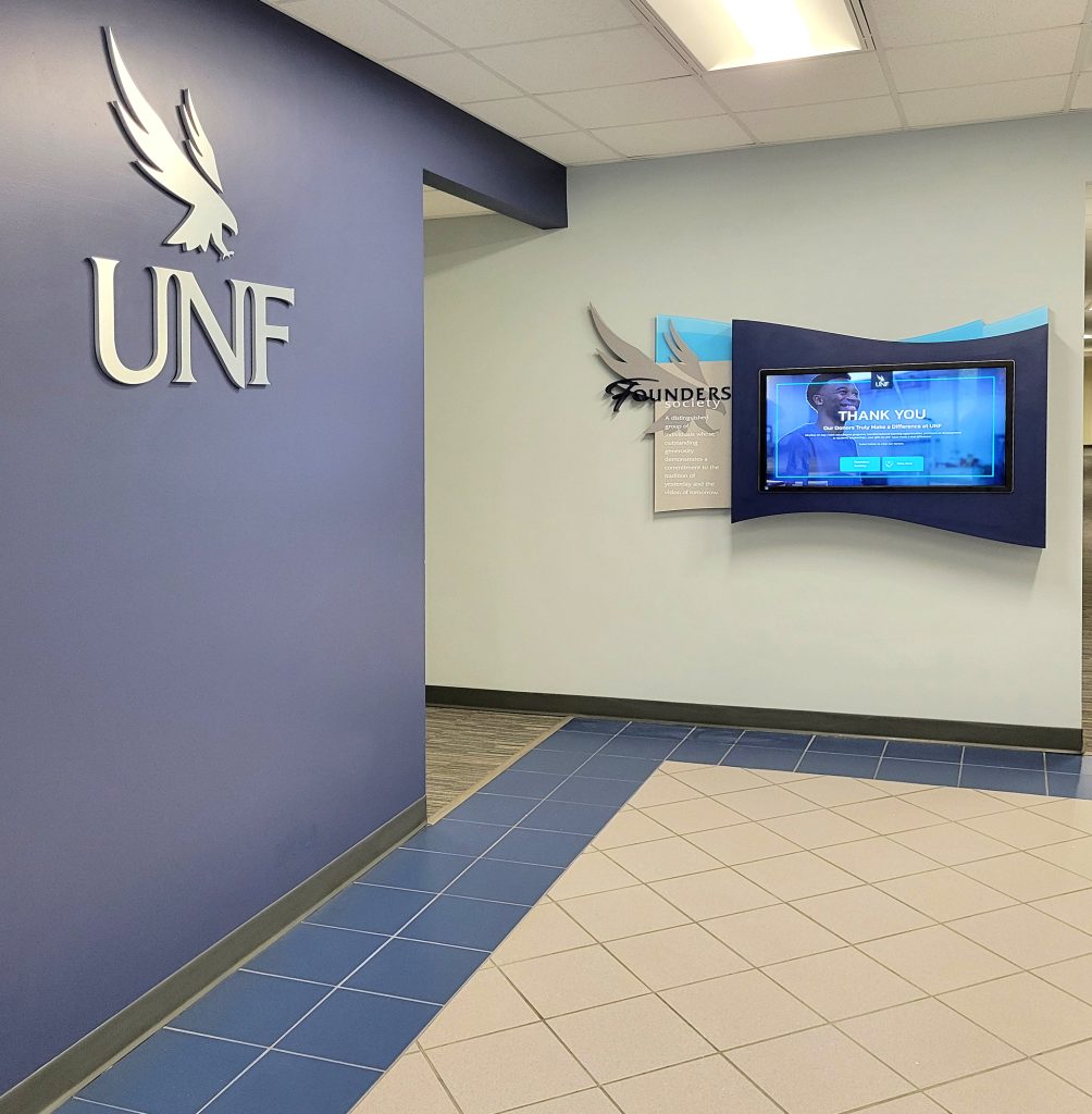 Interactive donor recognition display with UNF Osprey logo and Founders Society installation at Alumni Hall.