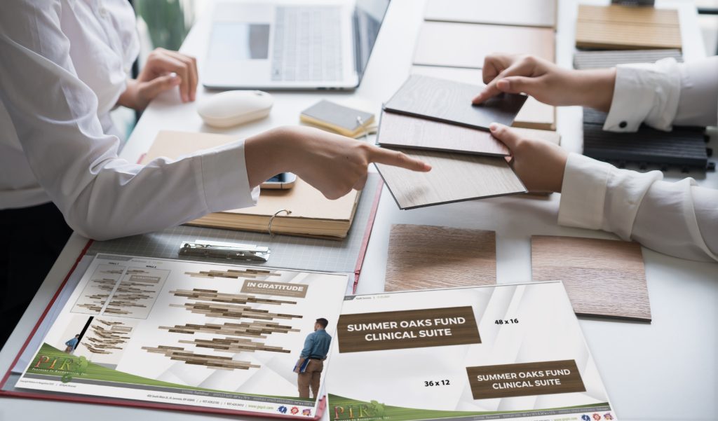 Donor recognition consultants working with their clients to find the correct color samples for their environment that can be applied toward their donor recognition display