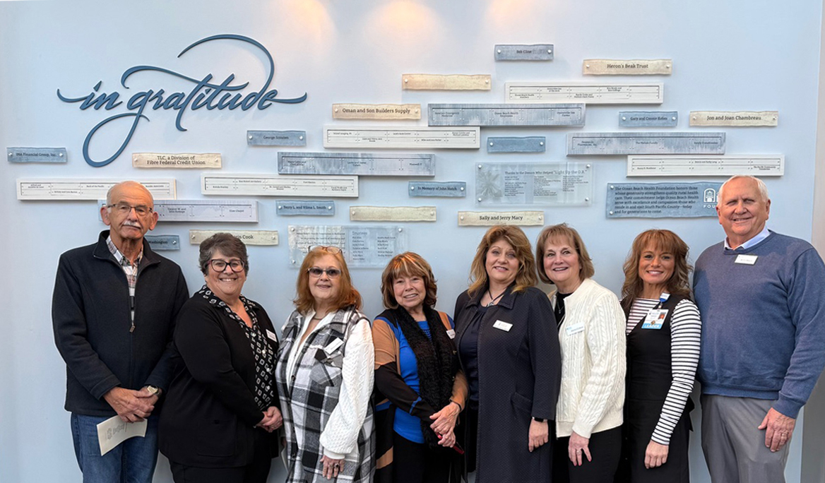 Attendees interacting with the donor recognition wall during the unveiling event, reflecting community response and donor pride.