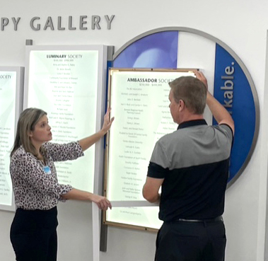 Donor recognition consultant advising a client how to update their donor recognition display