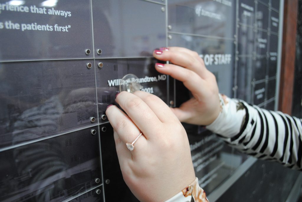 Donor relations updating a donor recognition display by changing out a nameplate.