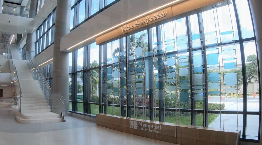 Donor recognition display integrated into a glass lobby preserving natural light and architectural sightlines in a healthcare environment