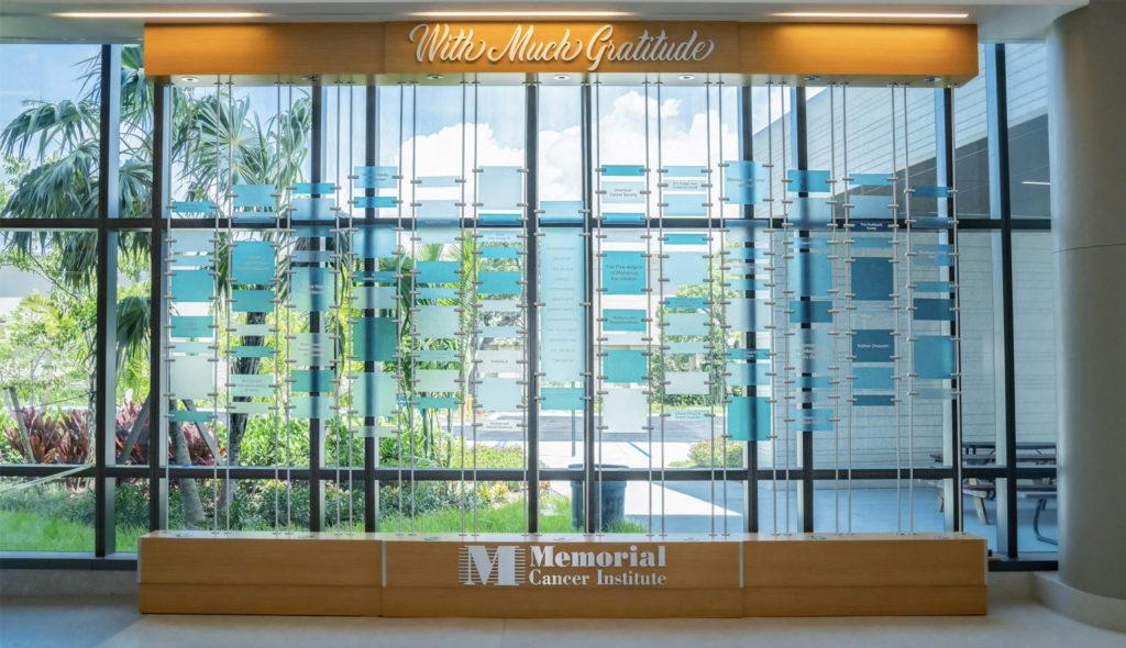 Glass wall donor recognition display at Memorial Cancer Institute featuring a suspended capital campaign donor wall system