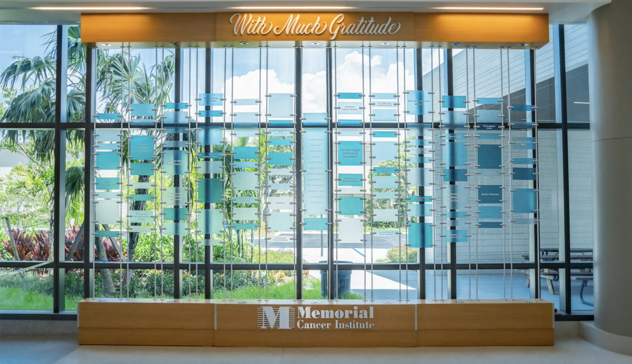 Glass wall donor recognition display at Memorial Cancer Institute featuring a suspended capital campaign donor wall system