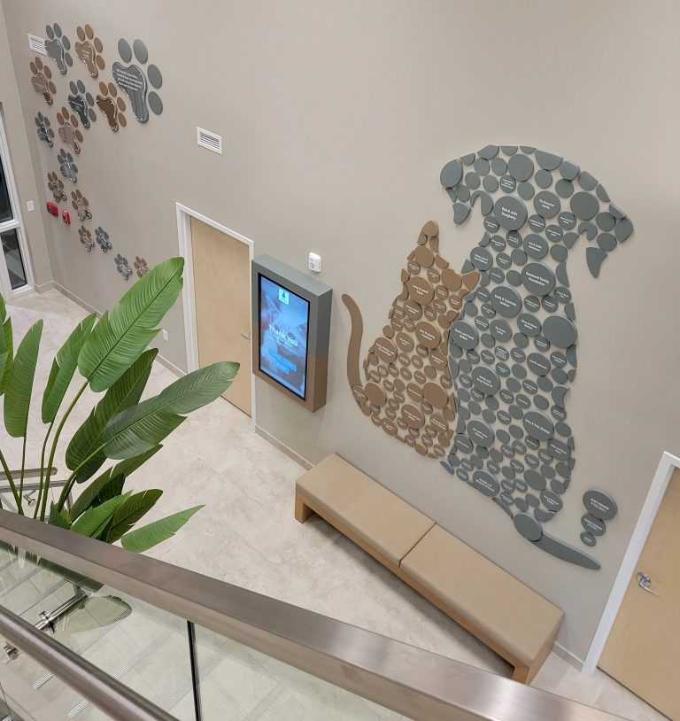 Donor names are applied to the wall to create the image of the Grayvik Animal Shelter logo.