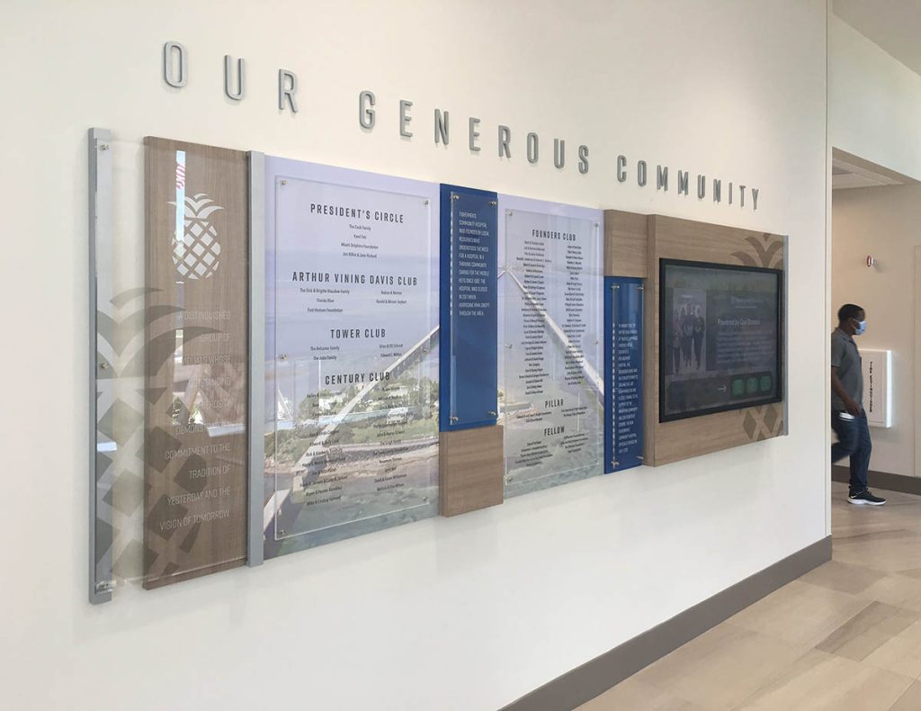 Hybrid donor recognition wall combining digital donor recognition with static donor panels in a healthcare facility.