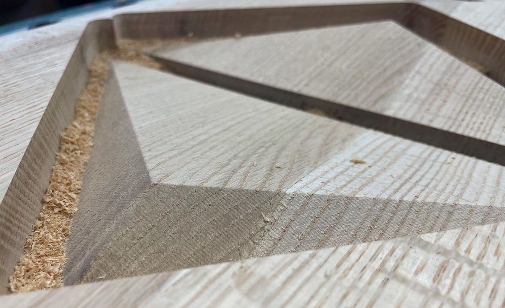 Close-up of routed wood detail being fabricated for a custom dimensional donor recognition display.