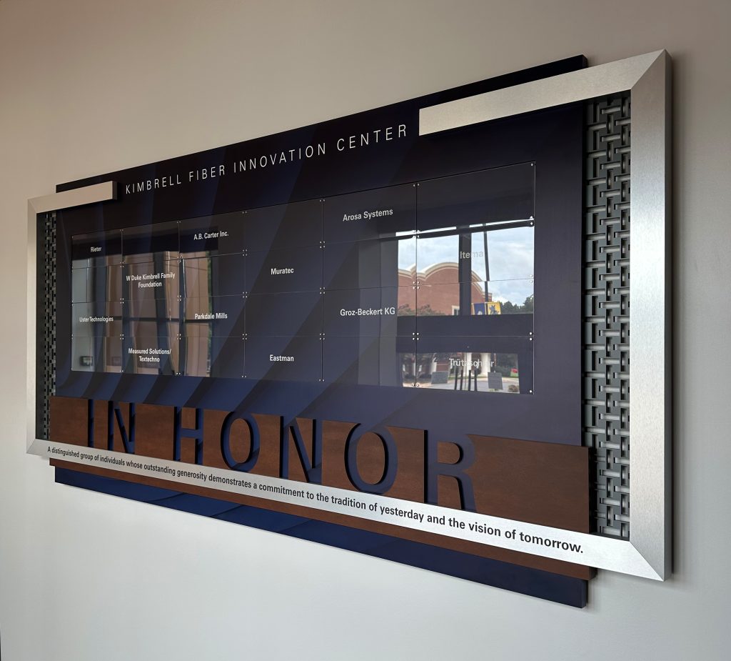 Corporate donor display featuring names of businesses that contributed to their capital campaign at the college level.
